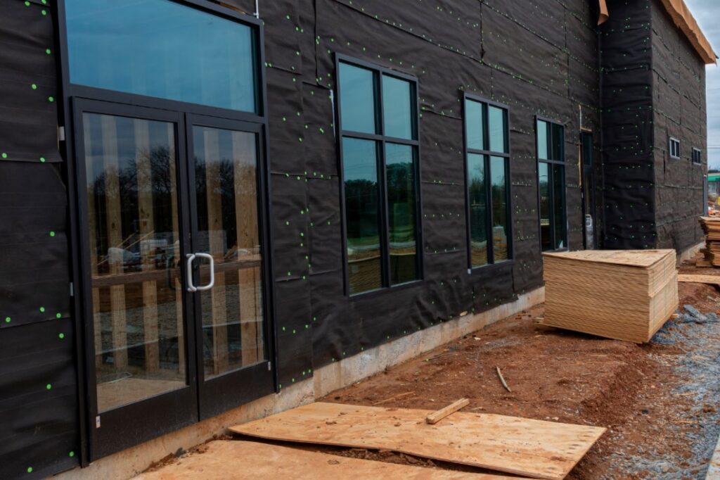 Planks of wood outside an unfinished commercial building done by Idaho Falls Commercial Construction Apollo Construction Company Inc.
