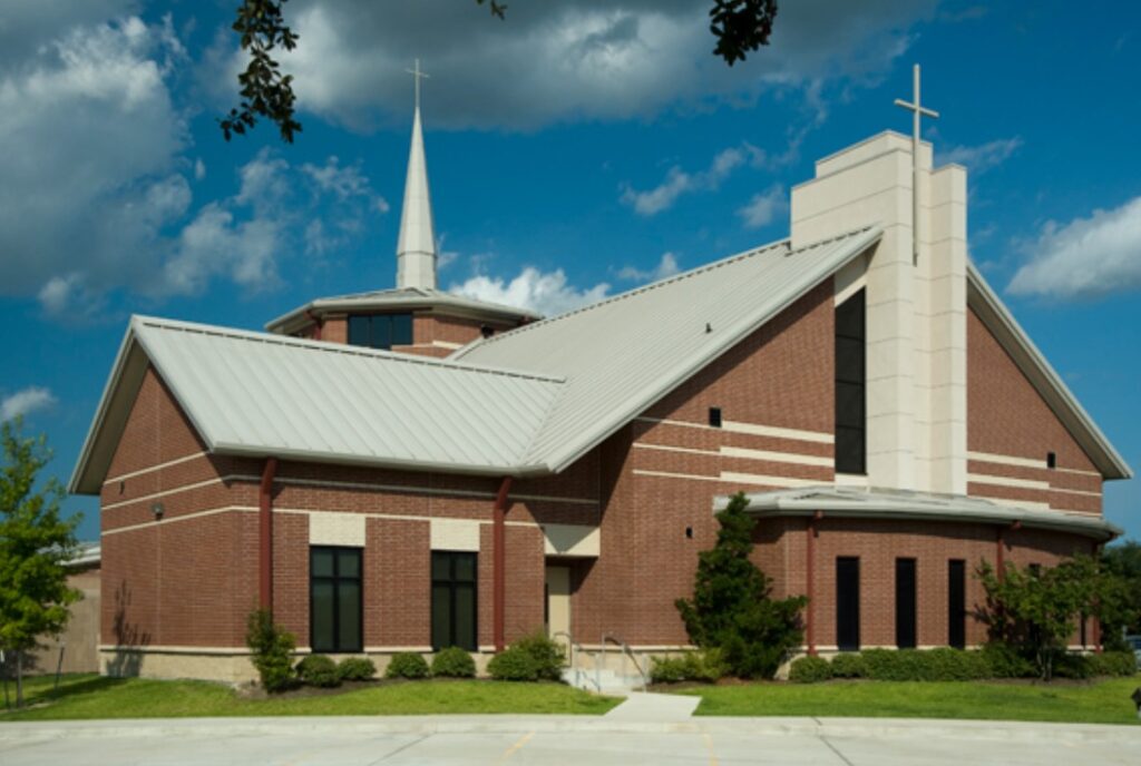 Completed church building with steel structures and red brick surround by Idaho Falls Metal Construction Company Apollo Construction Company Inc.