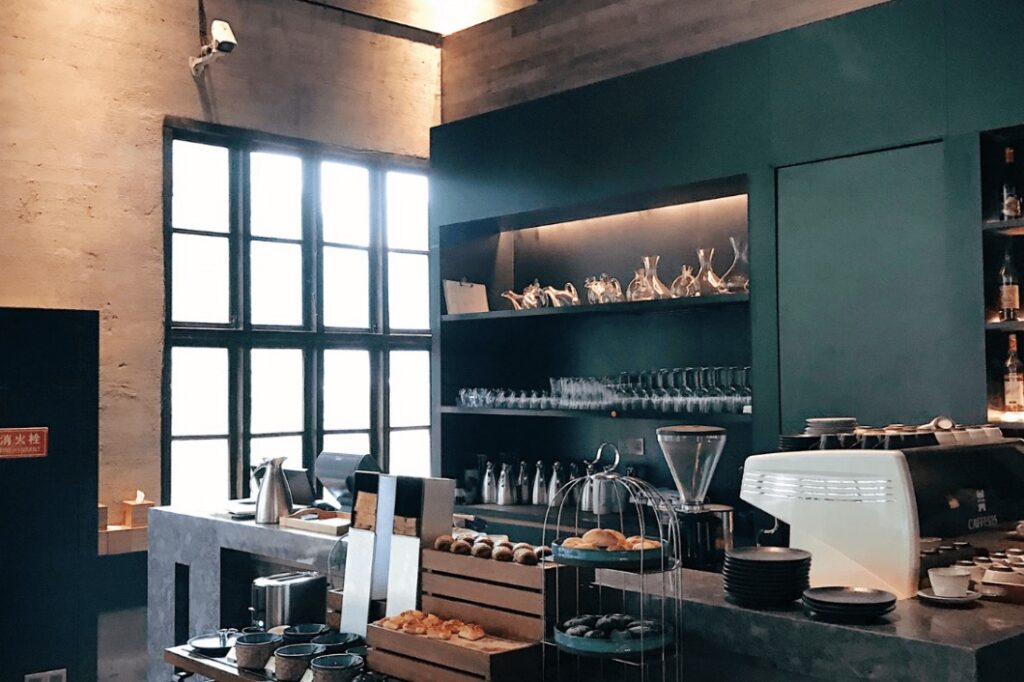 Small coffee shop with tall windows and a neat front counter by Idaho Falls Commercial Construction Apollo Construction Company Inc.