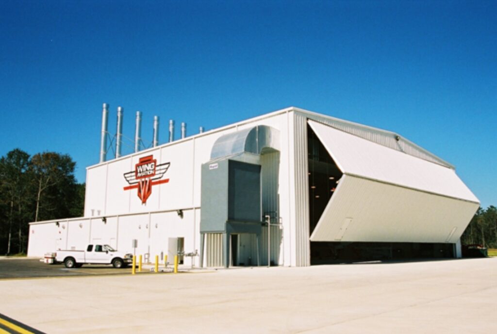 Rigid buildings large white building with massive garage door and AC unit - Idaho Falls Metal Construction Company Apollo Construction Company Inc.