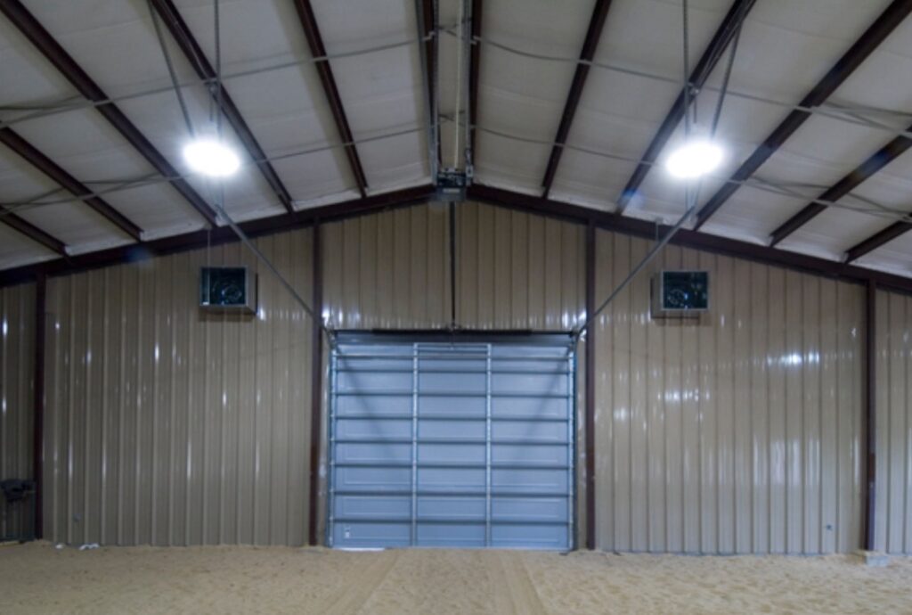 A completed full metal warehouse with garage door and overhead lighting - Idaho Falls Metal Construction Company Apollo Construction Company Inc.