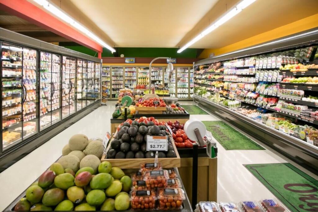 Grocery store of fresh fruit in the center isle and full shelves on the sides after completion by Idaho Falls Commercial Construction Apollo Construction Company Inc.