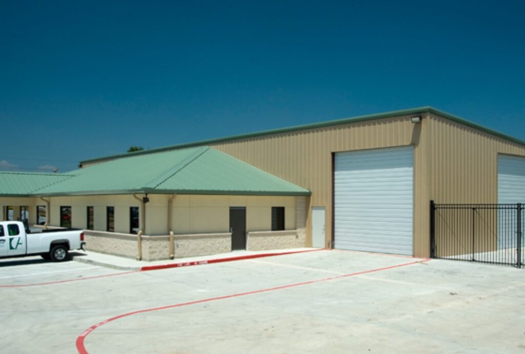 Large business metal building addition with garage doors and green roof done by Idaho Falls Metal Construction Company Apollo Construction Company Inc.