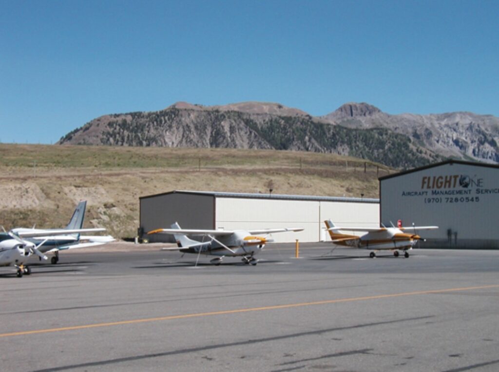Two white aviation buildings and three small planes - constructed by Idaho Falls Metal Construction Company Apollo Construction Company Inc.